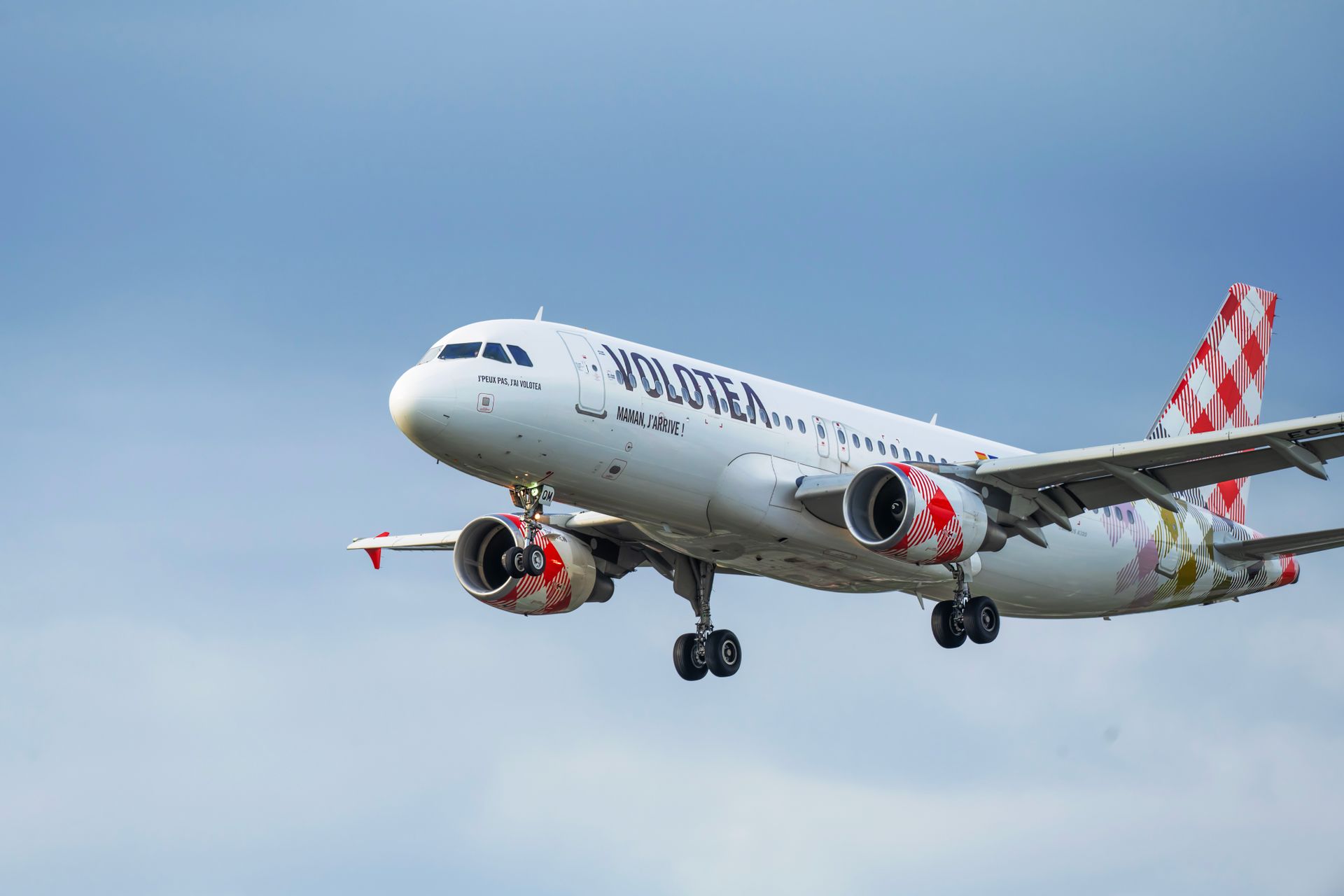Commercial airplane from Volotea Airlines flying in the sky offers a dynamic perspective.