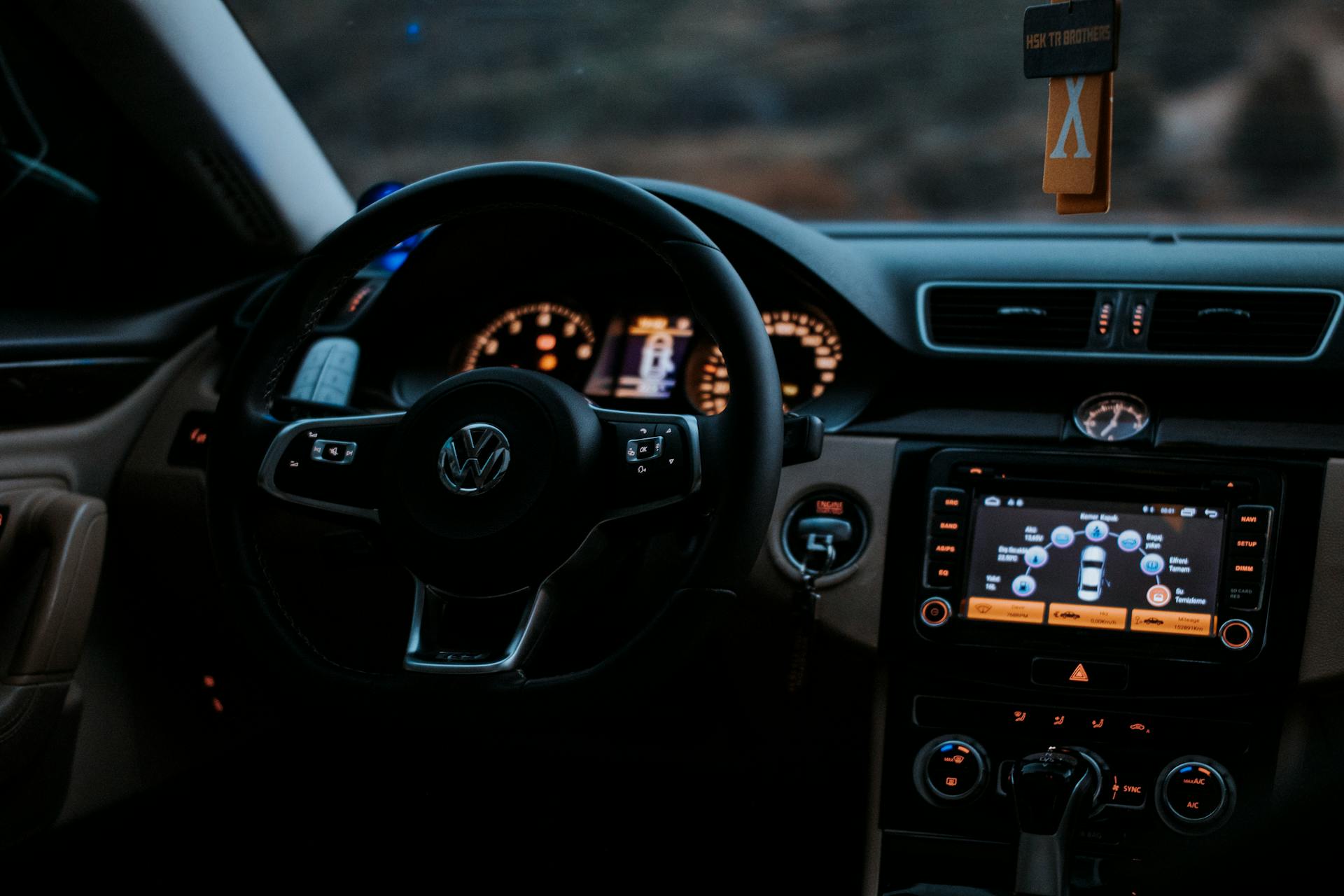 Cozy Volkswagen car interior showing dashboard display and steering wheel.