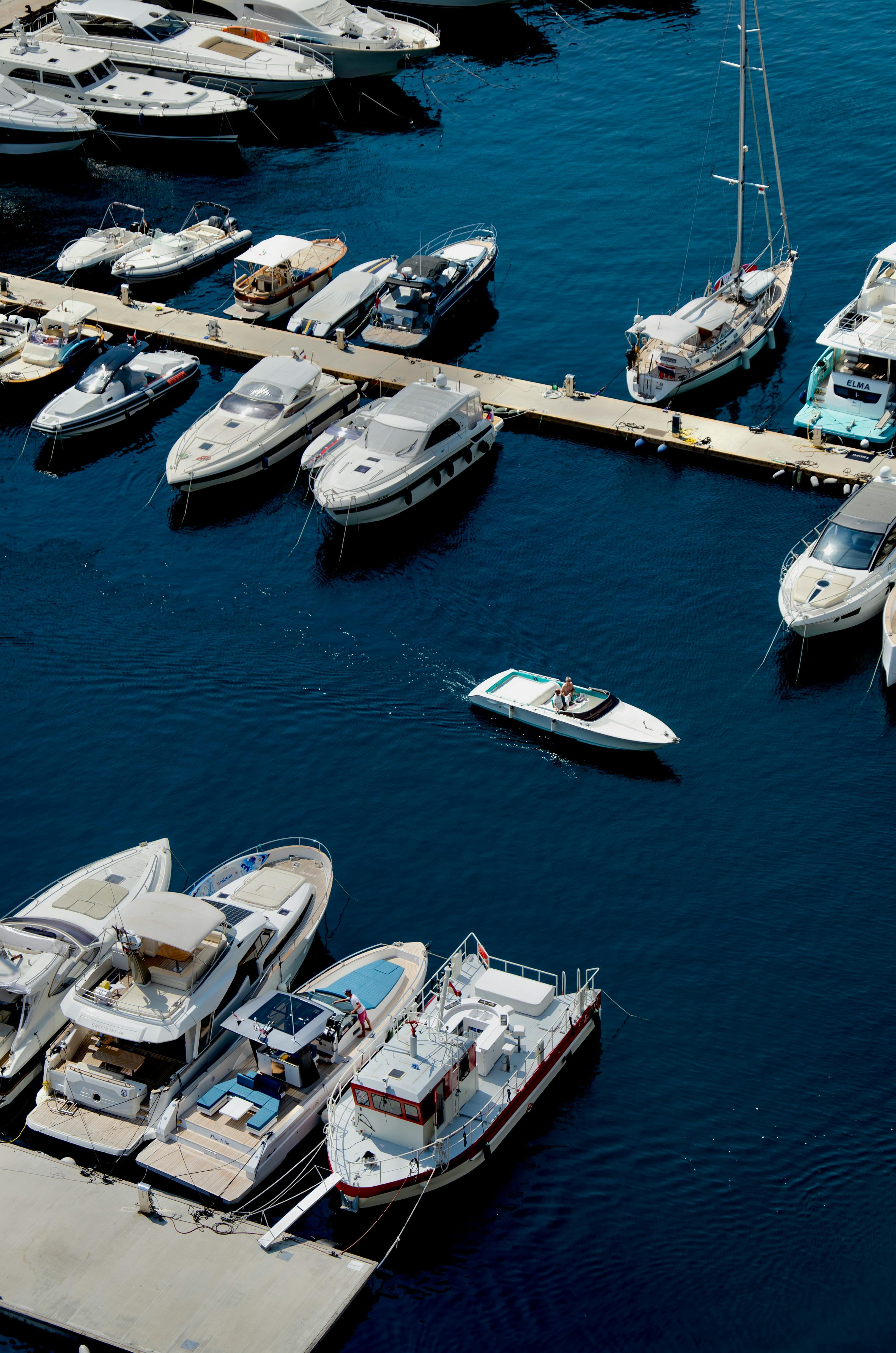 A scenic view of yachts and boats moored in the pristine waters of a Monaco marina.