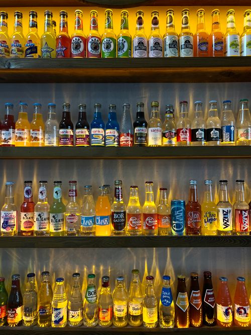Free Vibrantly lit beverage display in Türkiye showcasing a variety of colorful bottled drinks. Stock Photo