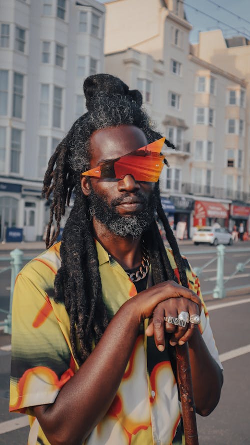 Man in Sunglasses and with Dreadlocks on Street