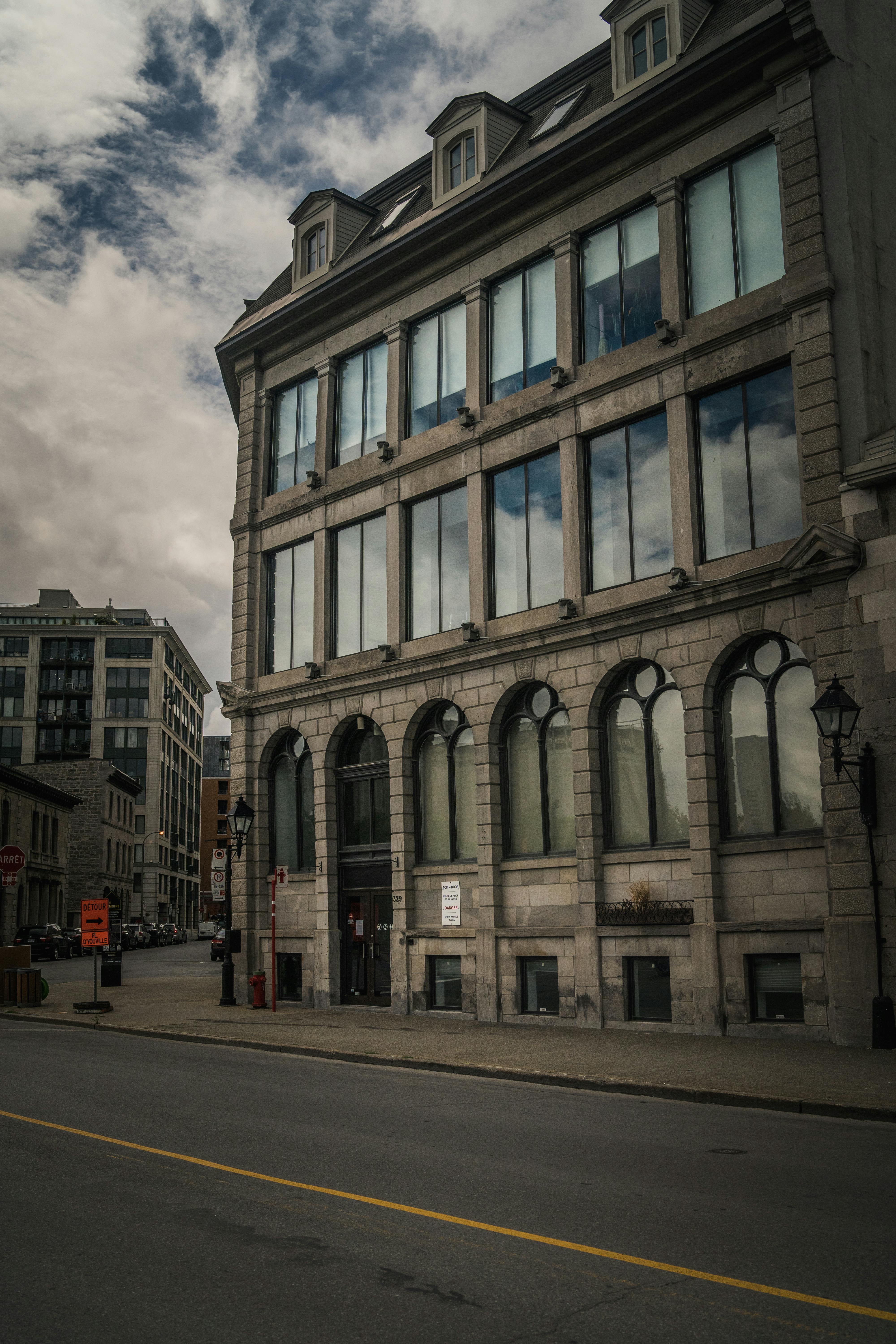 White Clouds Reflecting in Windows of Urban Building Free Stock