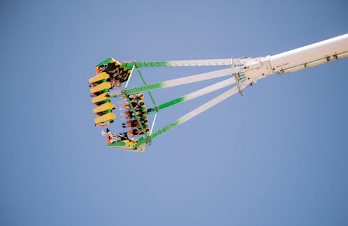 Young People on a Funfair Ride against Blue Sky