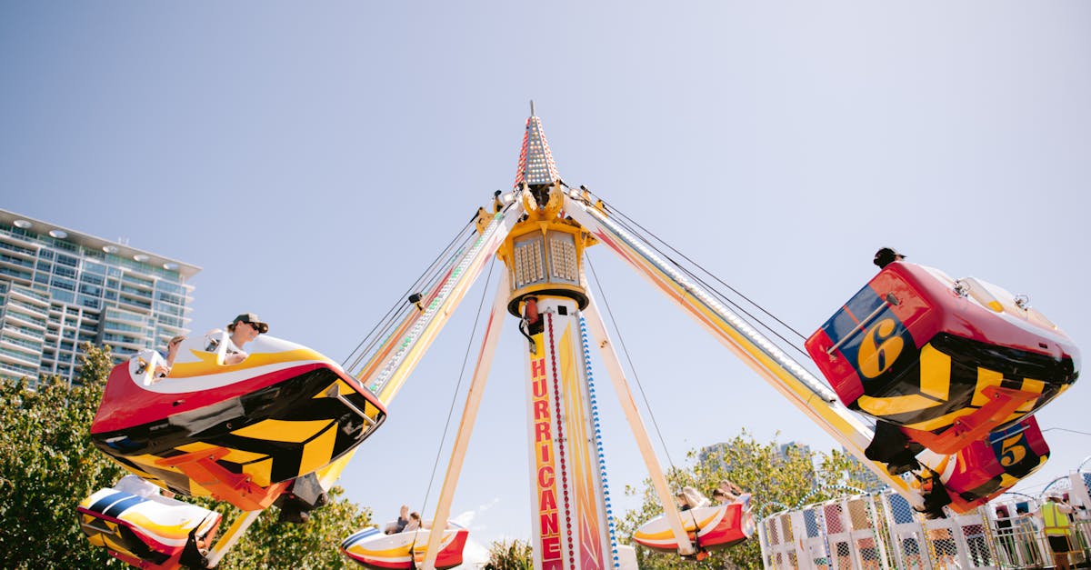 Exciting amusement park ride 'Hurricane' spinning under bright blue sky, capturing fun and adventure.