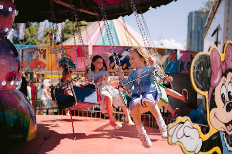 Girls On A Carousel On A Sunny Day