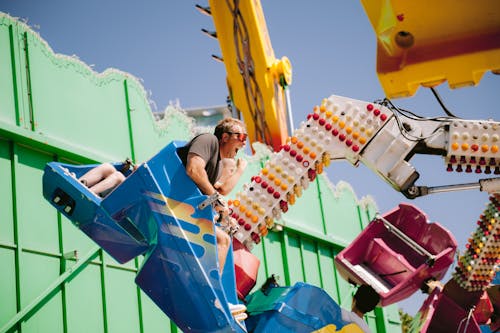 Man Screaming in Amusement Park Carousel Ride