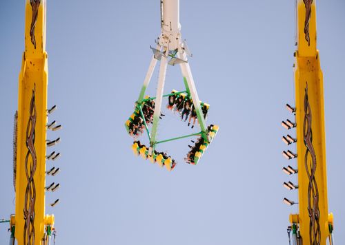 Free Exciting ride at an amusement park with people enjoying the thrill. Stock Photo