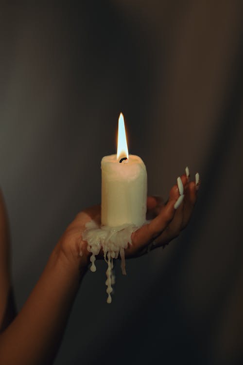 Woman Holding a Burning Candle in her Hand 