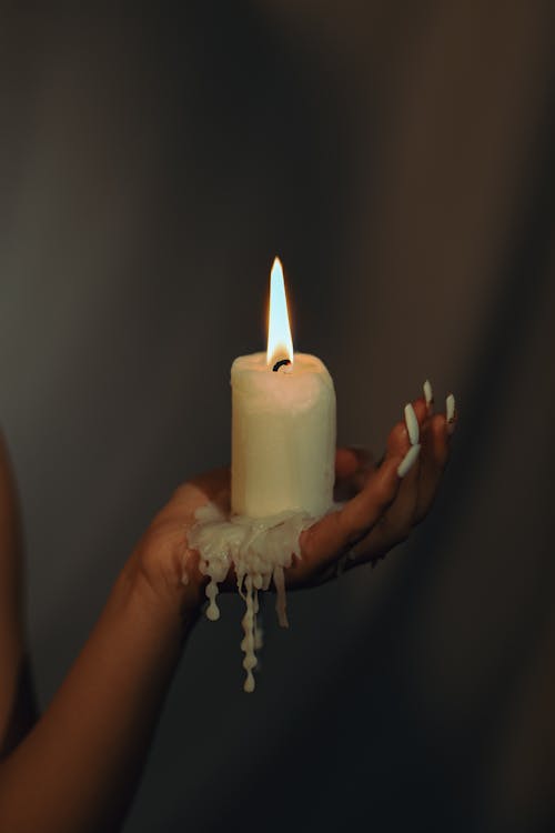 Free Woman Holding a Burning Candle in her Hand  Stock Photo