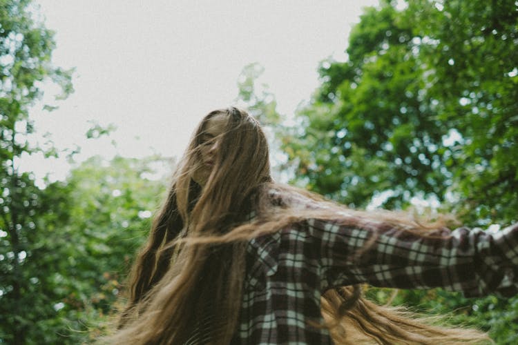 Woman With Long Hair Among Trees