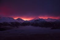 白雪皑皑的山脉上，壮观的日出让天空充满活力