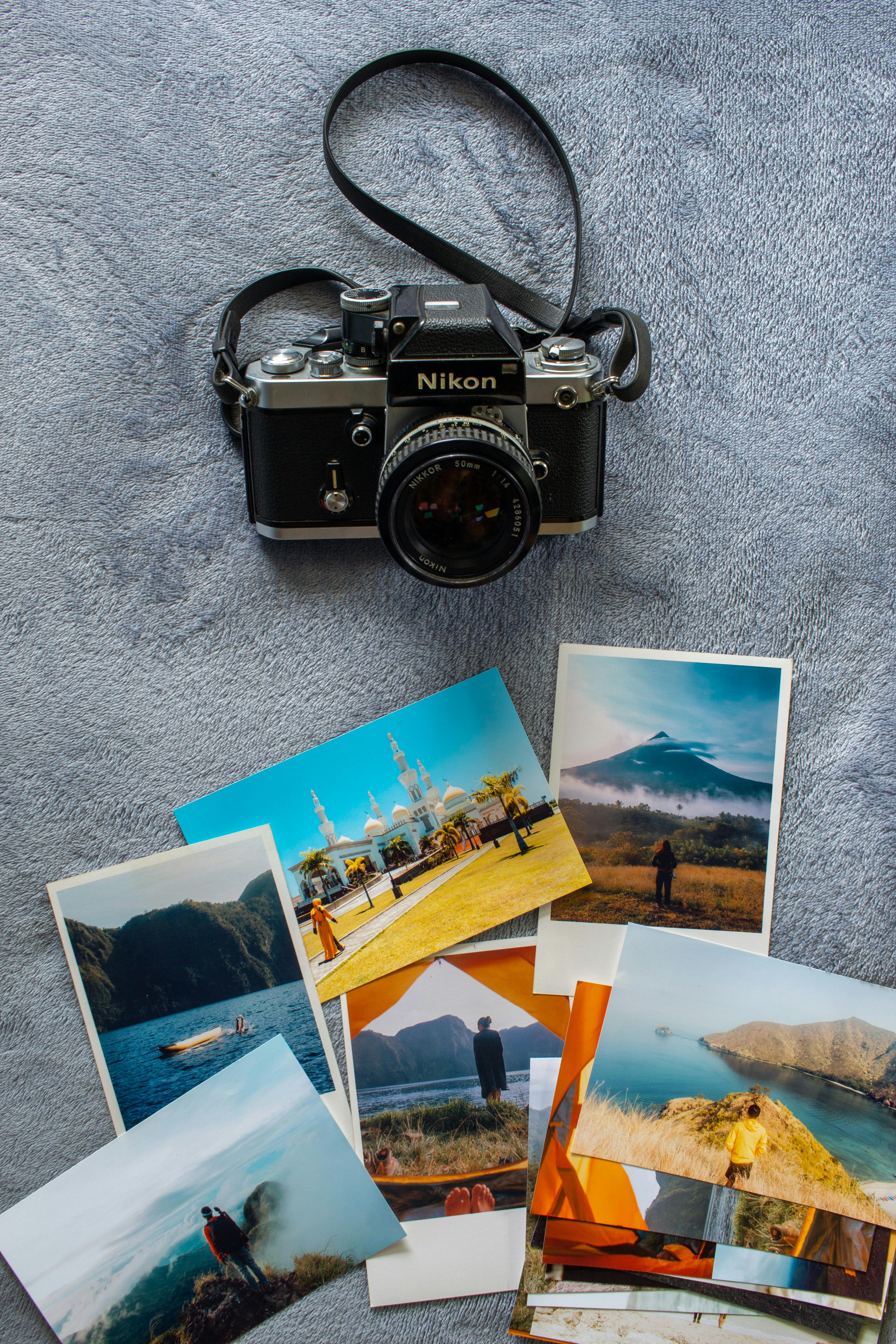 Black and Silver Canon Dslr Camera on White Paper · Free Stock Photo