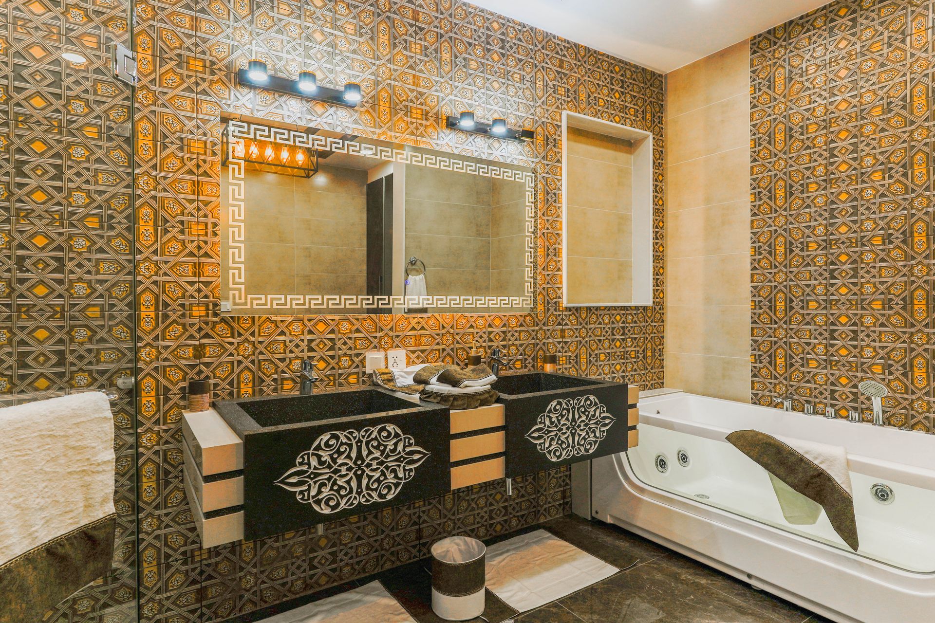 Elegant bathroom with Moroccan tile design, featuring a double sink and modern bathtub.