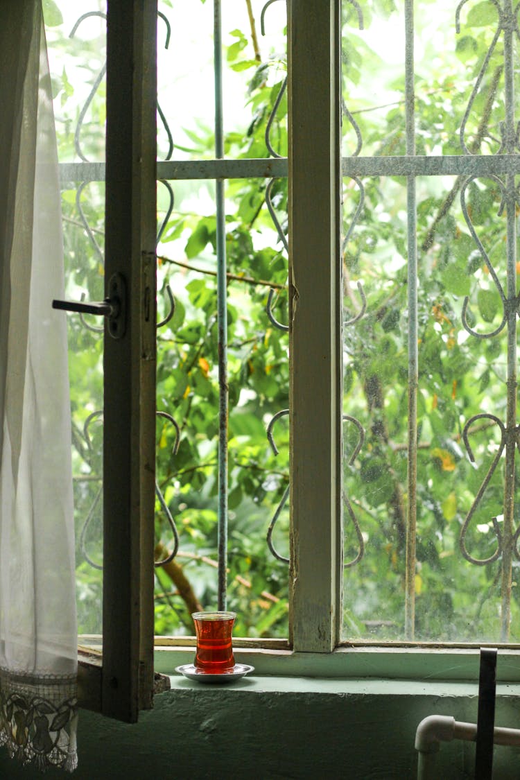 Glass Of Tea On An Old Barred Window