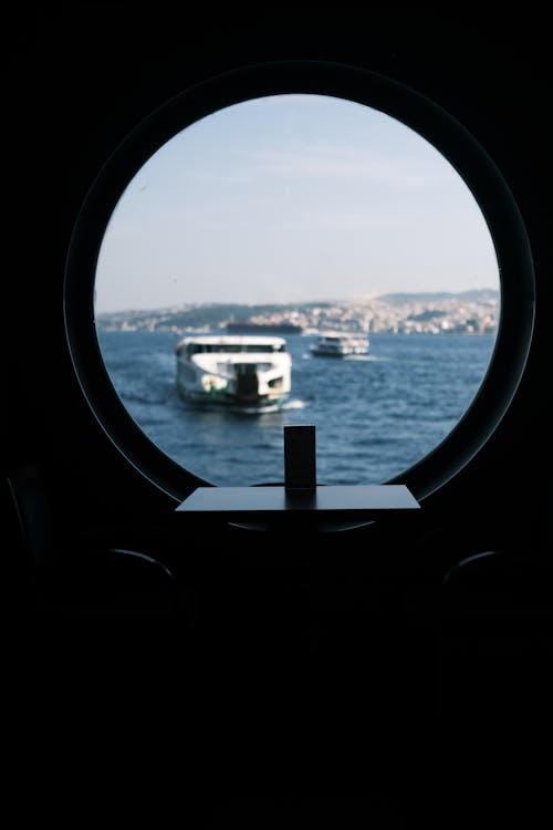 View of Ships from a Round Window of a Ferry 