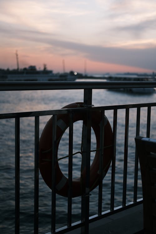 A Lifebuoy Ring on the Railing at Sunset 