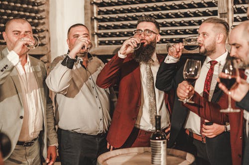 Men in Suits Drinking Wine