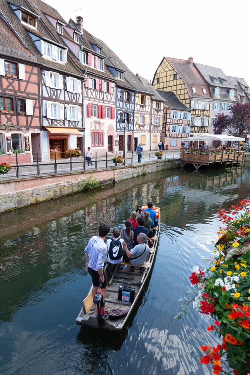 Free Quaint scene of a boat on a canal in historic Colmar, France. Stock Photo
