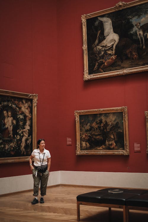 Woman Looking at Paintings in a Museum 