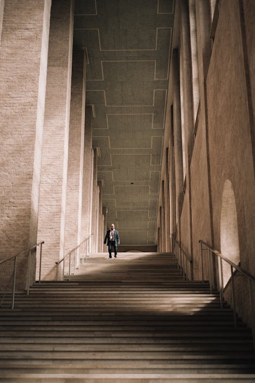 Man Walking Downstairs by Monumental Colonnade