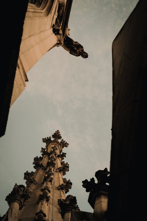 Free Gothic architectural details of a spire in Munich, showcasing intricate design under a moody sky. Stock Photo