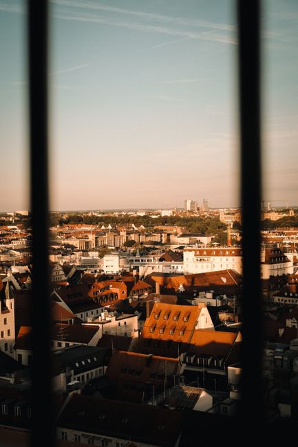 A vibrant view of Munich's rooftops bathed in sunset light, showcasing urban charm.