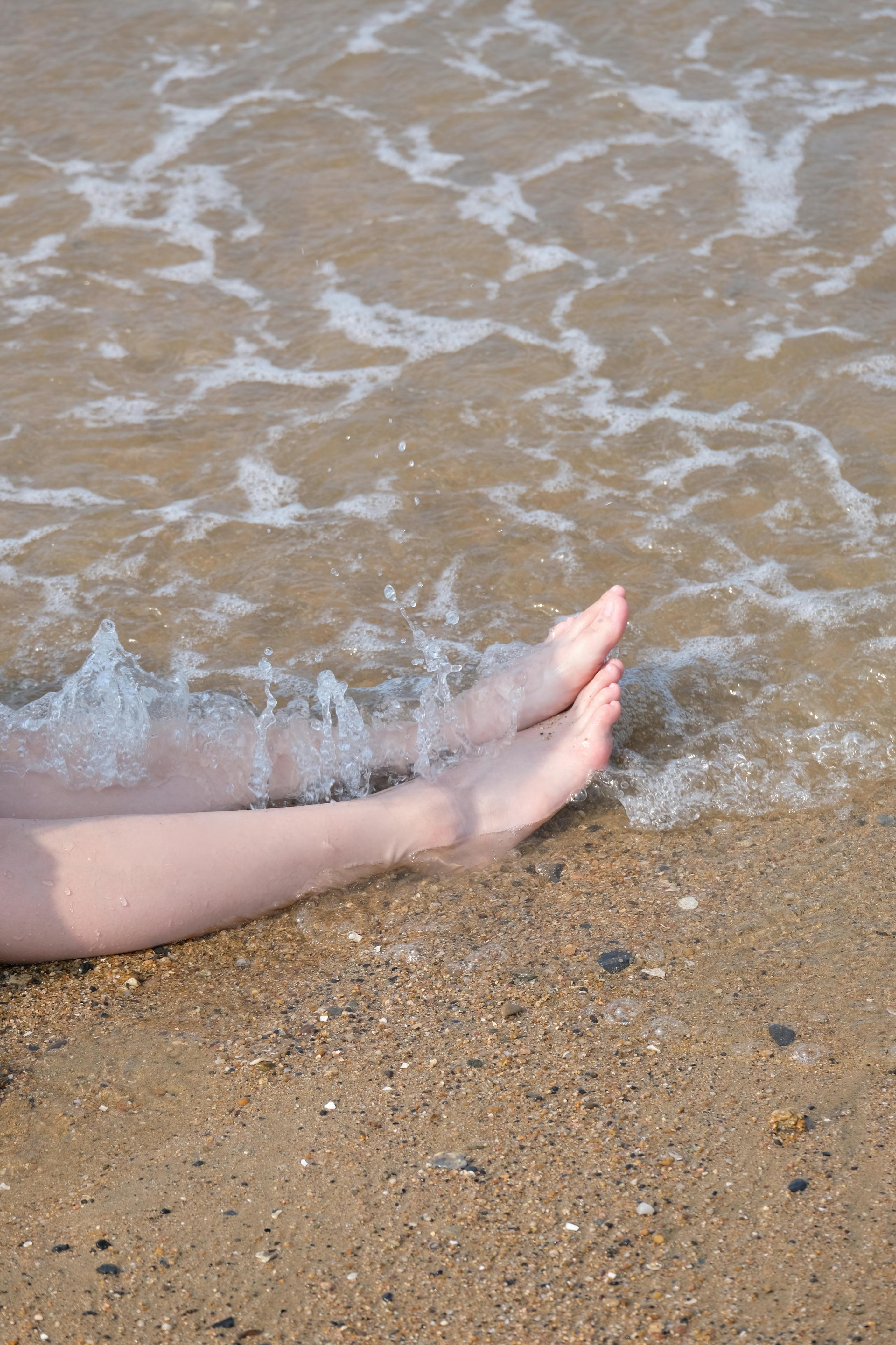 Feet on Wet Sand · Free Stock Photo