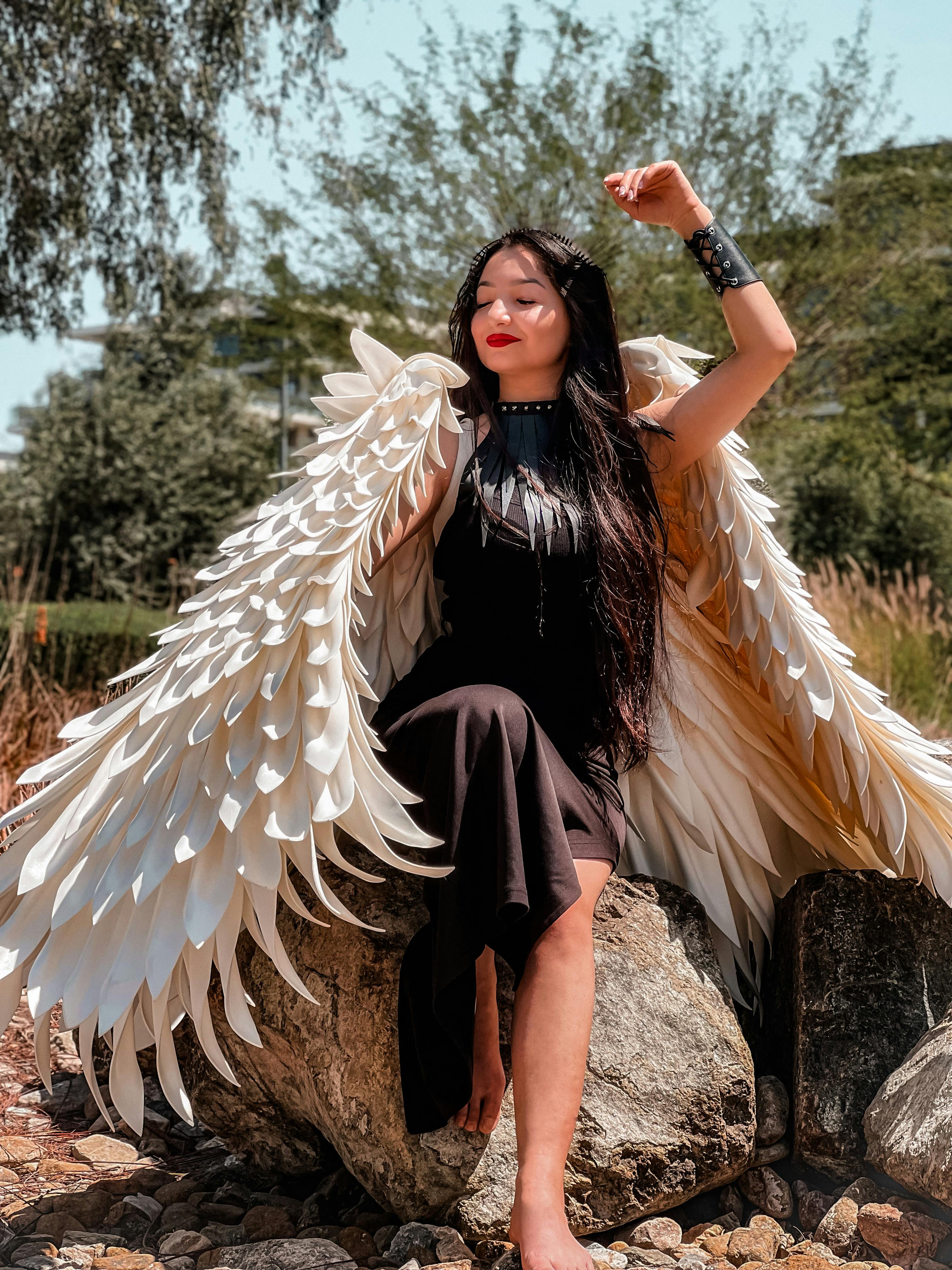 Woman in Black Dress Posing with Angel Wings · Free Stock Photo