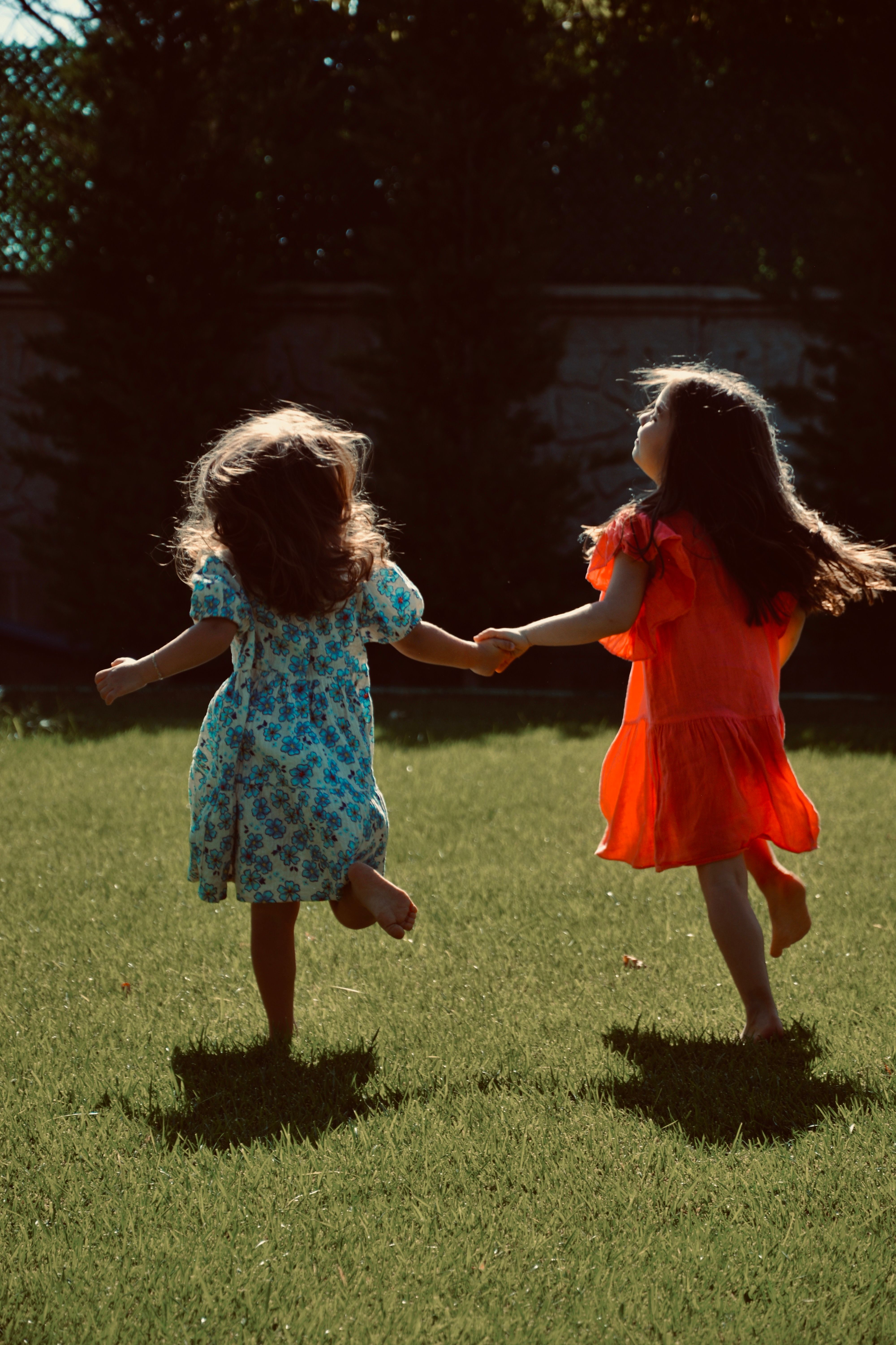 Girls in Dresses Holding Hands and Running on Grass · Free Stock Photo