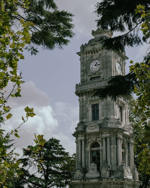 Free Ornate clock tower surrounded by trees in Istanbul, showcasing architectural beauty. Stock Photo