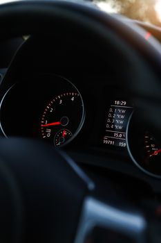Focused image of a car dashboard highlighting the speedometer and digital display.