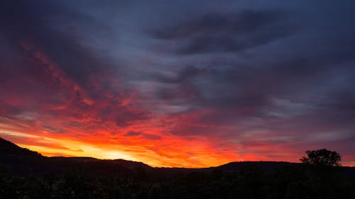 Red Sky at Sunset over Line on Hills