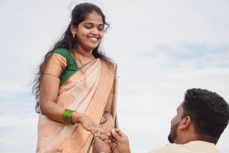 Man Proposing Engagement To Woman In Traditional Clothing