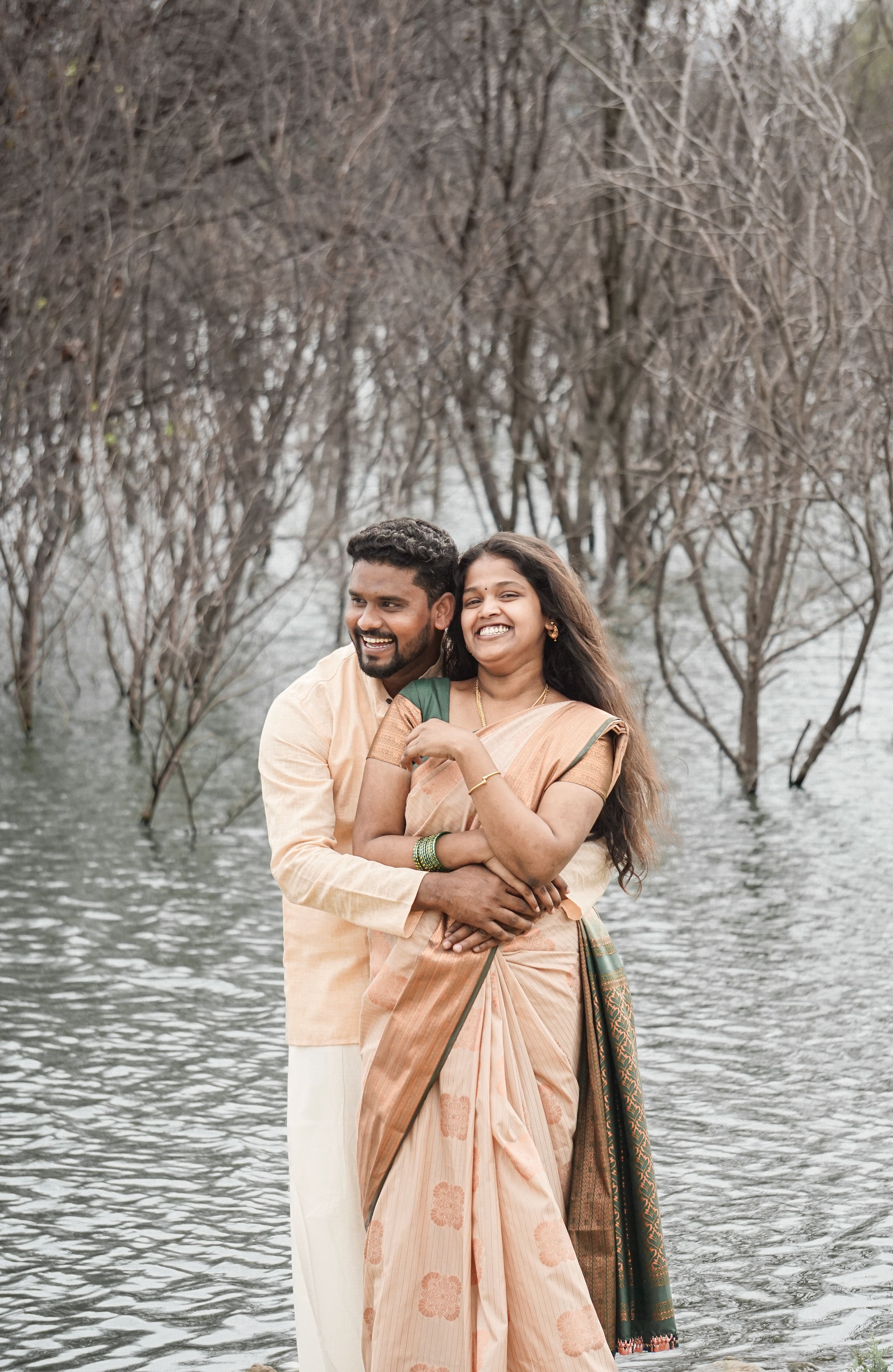Smiling Couple Hugging in Traditional Clothing · Free Stock Photo