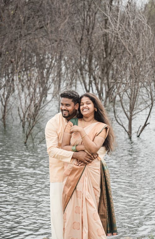 Smiling Couple Hugging in Traditional Clothing