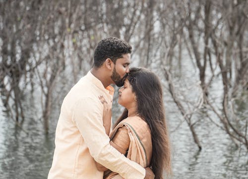 Man in Traditional Clothing Kissing Woman