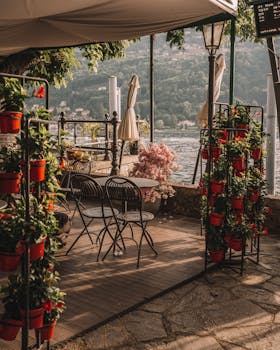 Tranquil patio with flowers overlooking Lake Maggiore in Stresa, Italy during summer.