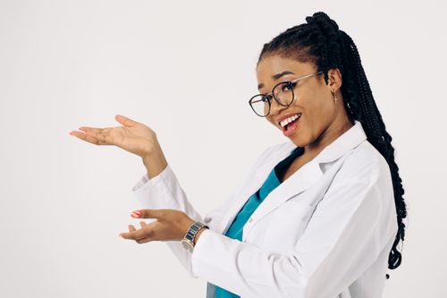 Free Professional female doctor with glasses, confidently presenting on a white background. Stock Photo