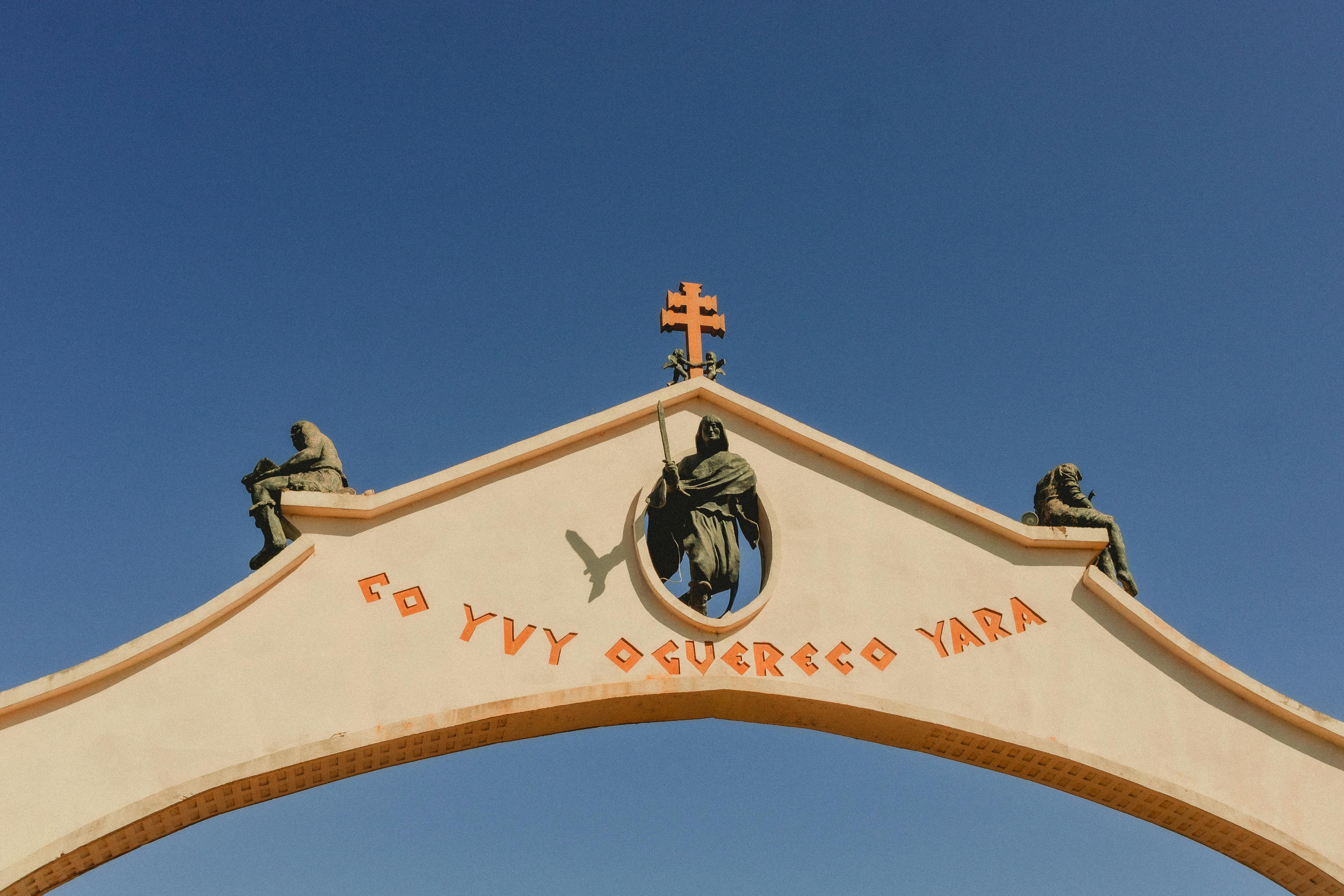 Historical arch in São Miguel das Missões, Brazil, under clear blue sky.