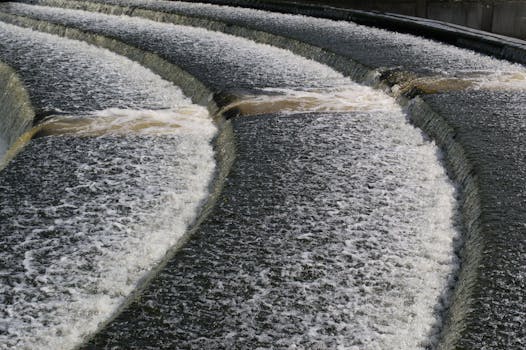 Dynamic view of a cascading waterfall over concrete steps in Lisburn, Northern Ireland.