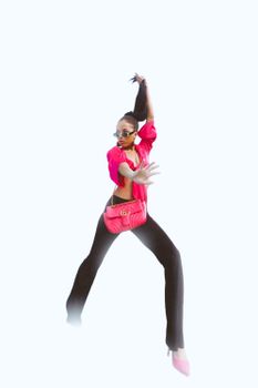 Confident woman in striking pose with vibrant pink accessories and sunglasses on white background.