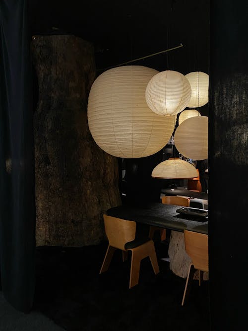 Paper Shining Electric Lamps Hanging Over Table
