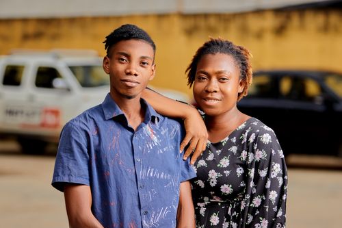 Free A fashionable couple poses together outdoors in an urban setting, showcasing modern style and connection. Stock Photo