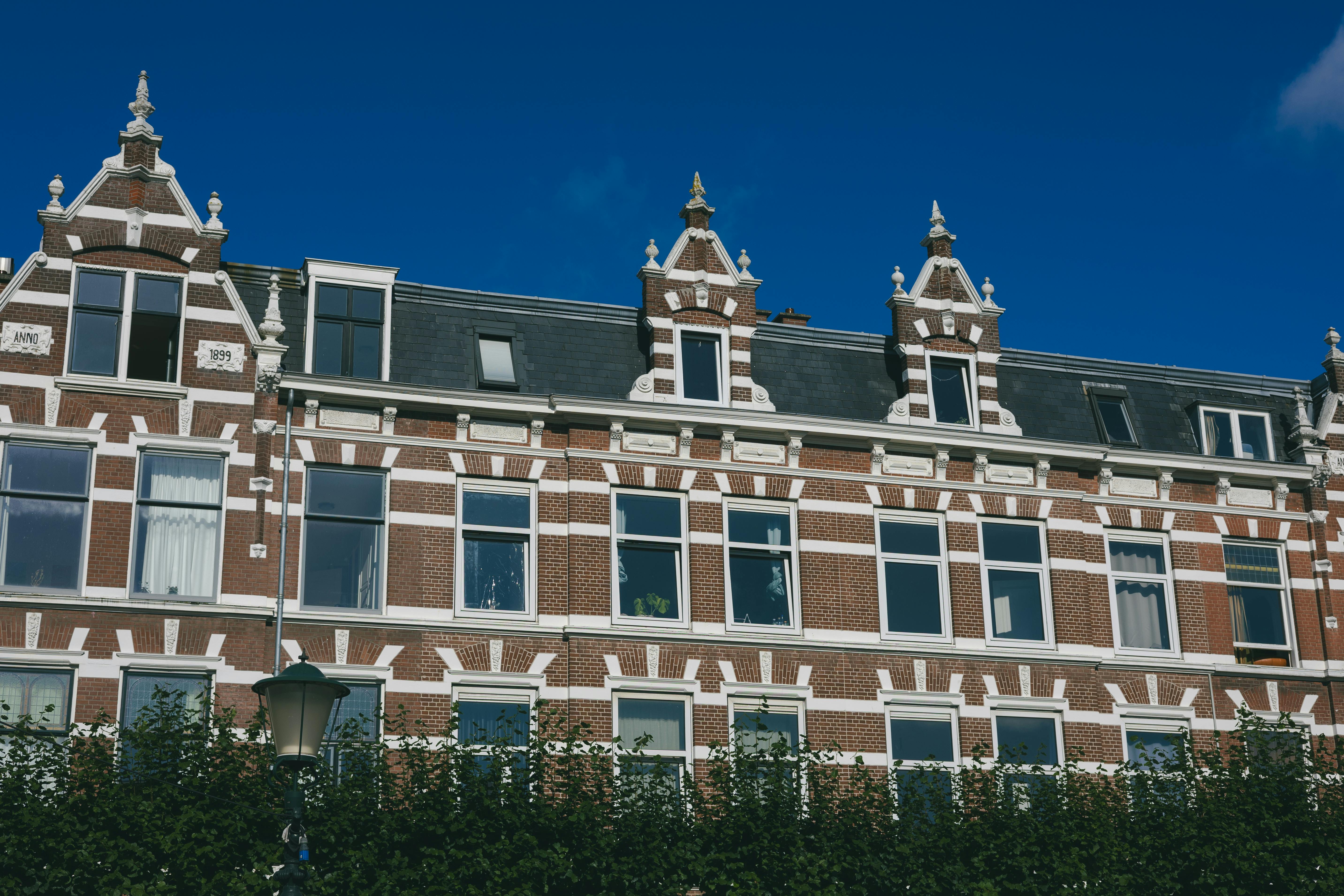 Traditional Dutch architecture in The Hague with classic gabled roofs under a clear blue sky.