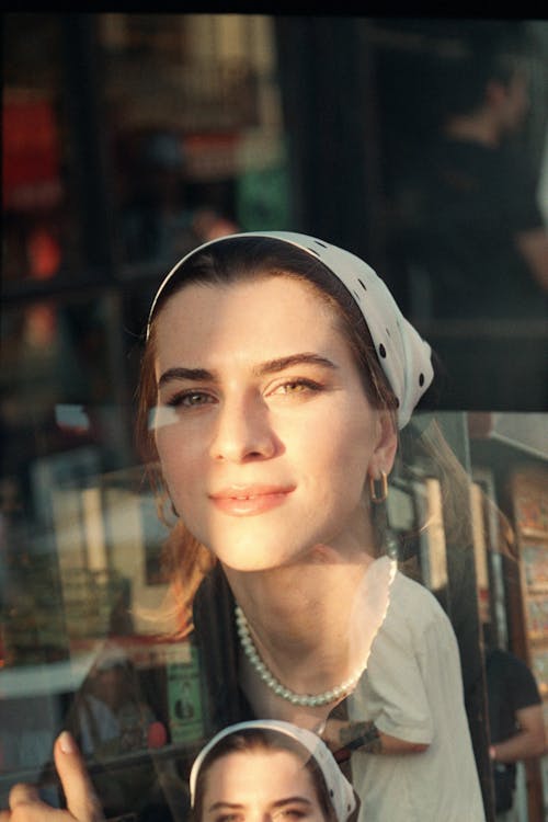 Portrait of a Smiling Young Woman Reflecting in the Window