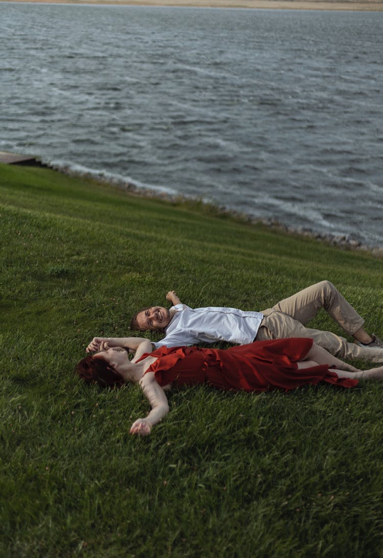 Man And Woman Lying Together On The Grass