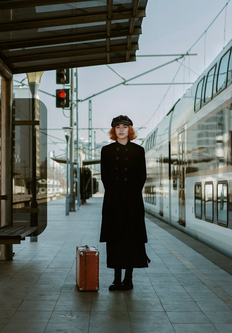 Woman In Retro Style Coat At Railway Station