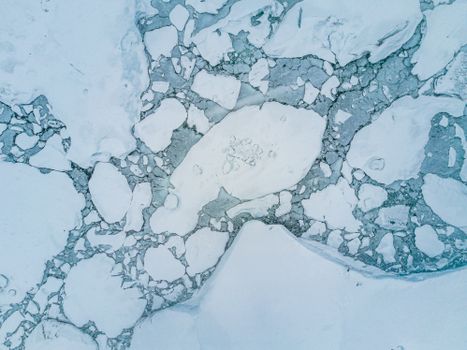 Stunning aerial shot of icy arctic landscape showcasing floating ice and calm winter sea.. pexels, stunning, aerial