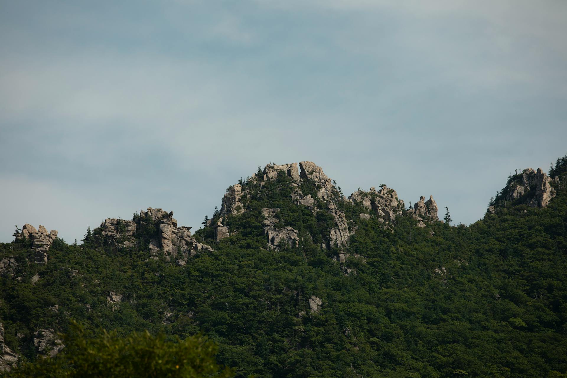 Rocky green mountains under a clear sky in Goseong-gun, South Korea.