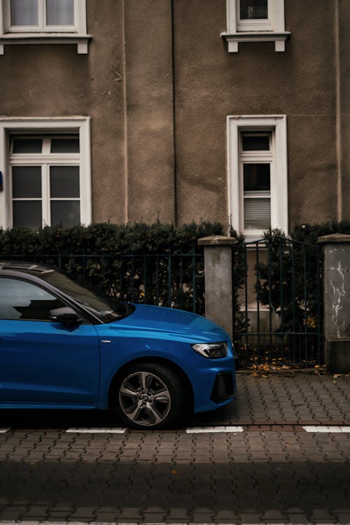 Blue Car Parked in front of Residential Building